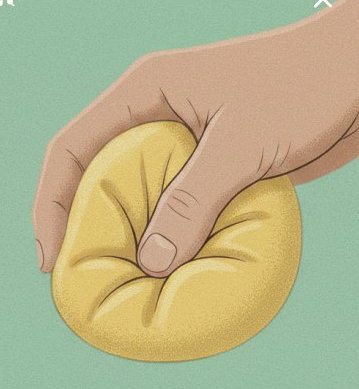 A hand slowly pressing a soft yellow pillow
